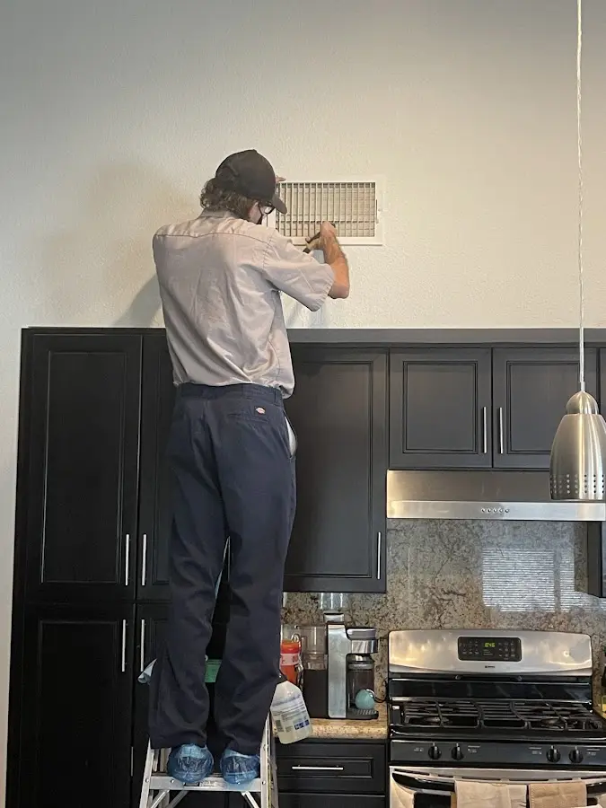 Technician inspecting an air vent during HVAC service in South Bradenton